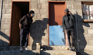 Sefonthoane Mohohla, 26, with his friend and neighbor, Kaemane Makhetha, who is his treatment supporter. 