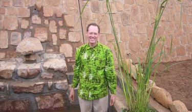 The late Dr. Paul Farmer stands in what will become a large garden in Rwinkwavu, Rwanda.