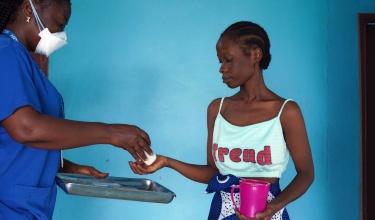 With support from arcTB, Ministry of Health registered nurse Beatrice M. Lehkaryean, left, provides the new WHO-approved regimen for multidrug-resistant tuberculosis to Comfort Yarkpawolo at the TB-Annex Hospital in Montserrado County, Liberia.