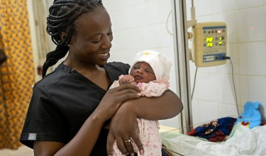 Evaline Ngige holds a baby Sia Mabinti Adebuba