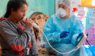 Jajaira (left) performs lung function tests as a participant of Socios En Salud's study on post-tuberculosis teens