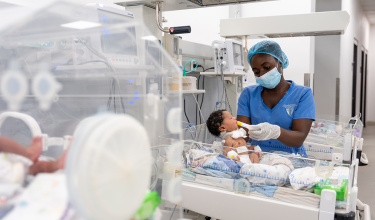 Nurse Danielle Jabati feeds a baby in the NICU