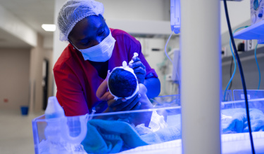 Nursing aid feeds newborn in NICU