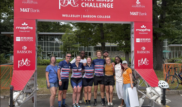 Members of Ekip Onkoloji, Partners In Health's PMC team, celebrate with friends and family at the finish line in Wellesley.